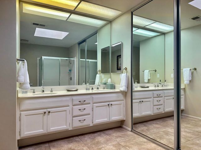 a bathroom with a double vanity sink and a mirror