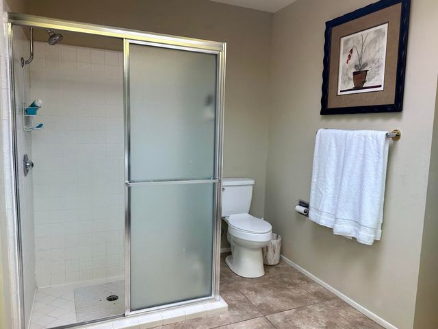 a bathroom with a toilet and a shower
