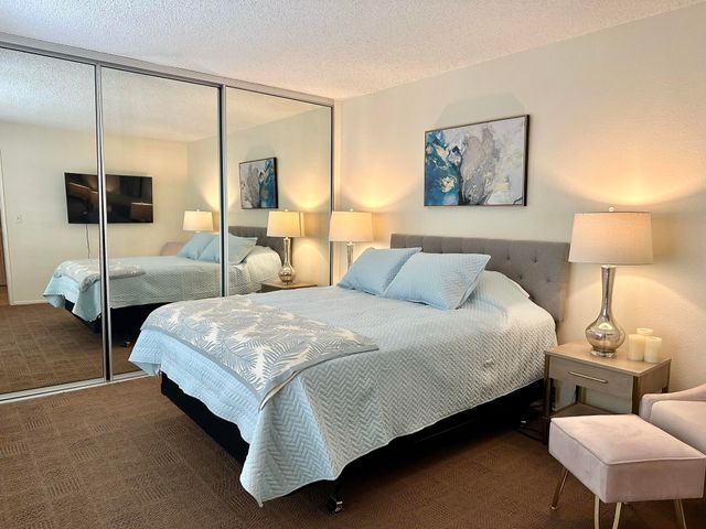 a bedroom with a bed a lamp and window