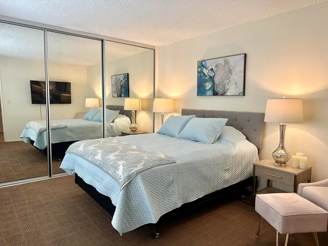 a bedroom with a bed a lamp and window