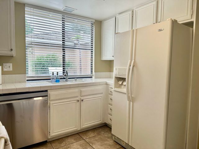 a kitchen with a refrigerator and a sink