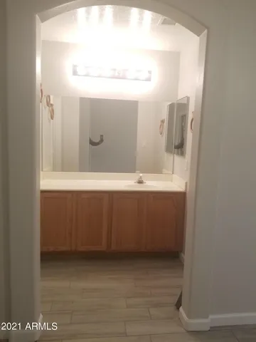 a bathroom with a sink a mirror and a vanity