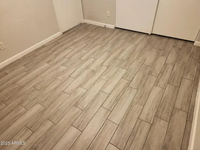 a view of a room with wooden floor