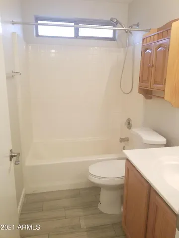 a bathroom with a shower a toilet and sink