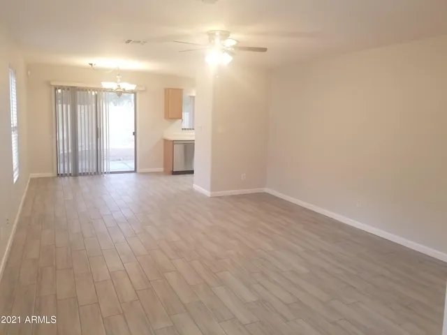 a view of a room with wooden floor and windows