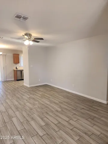 a view of a livingroom with a furniture chandelier fan and hardwood floor
