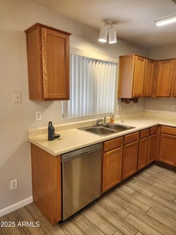 a kitchen with a sink cabinets and a window
