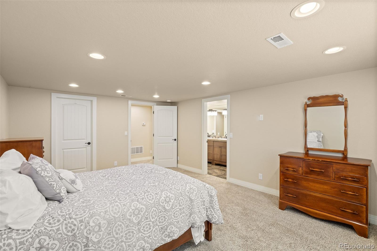 41865 East Muirfield Loop Elizabeth, CO 80107 - Photo 34 of 50 a bedroom with a bed and a dresser