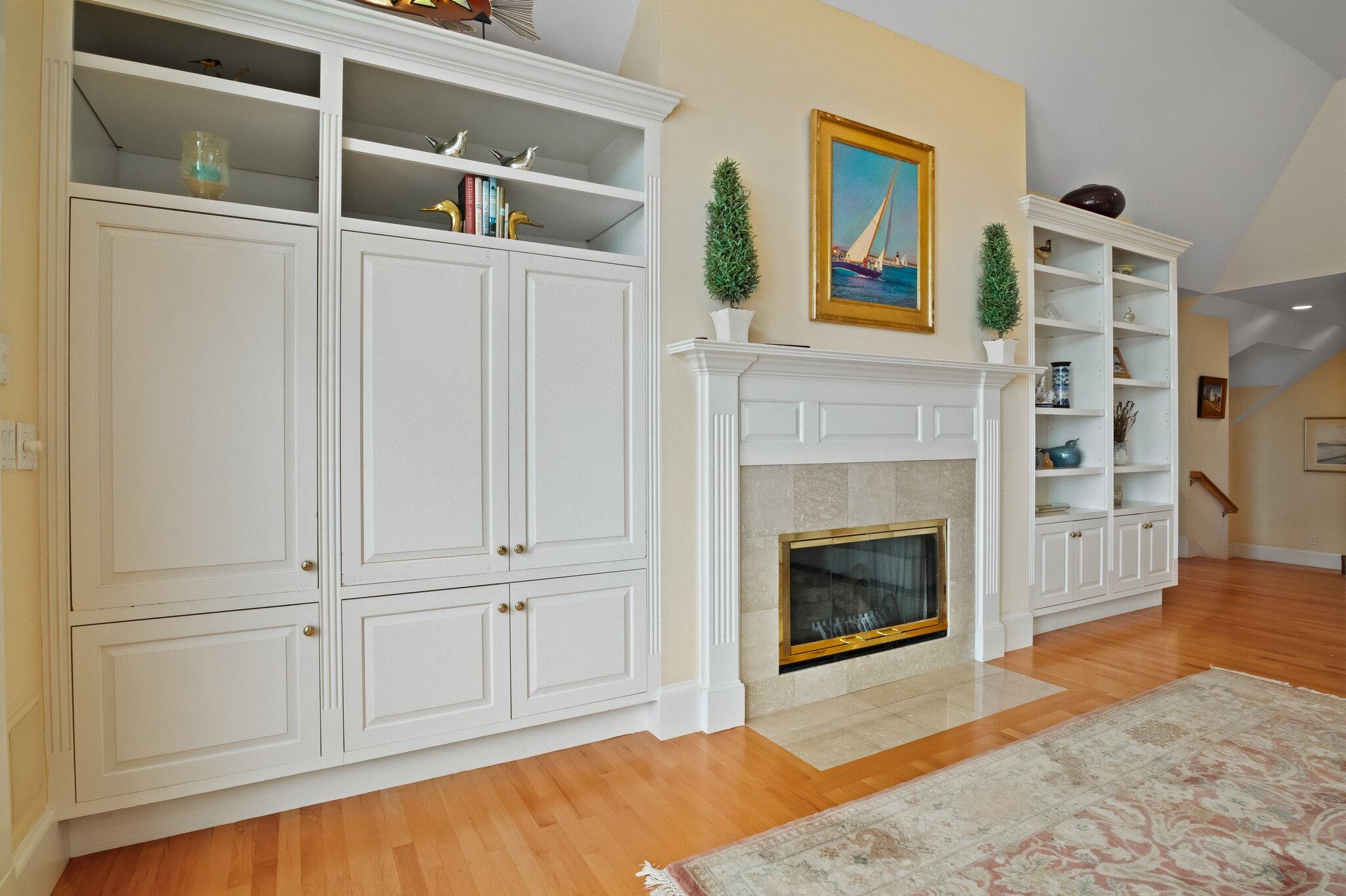 99 Center Lane Centerville, MA 02632 - Photo 12 of 89 a view of a livingroom with wooden floor and a fireplace