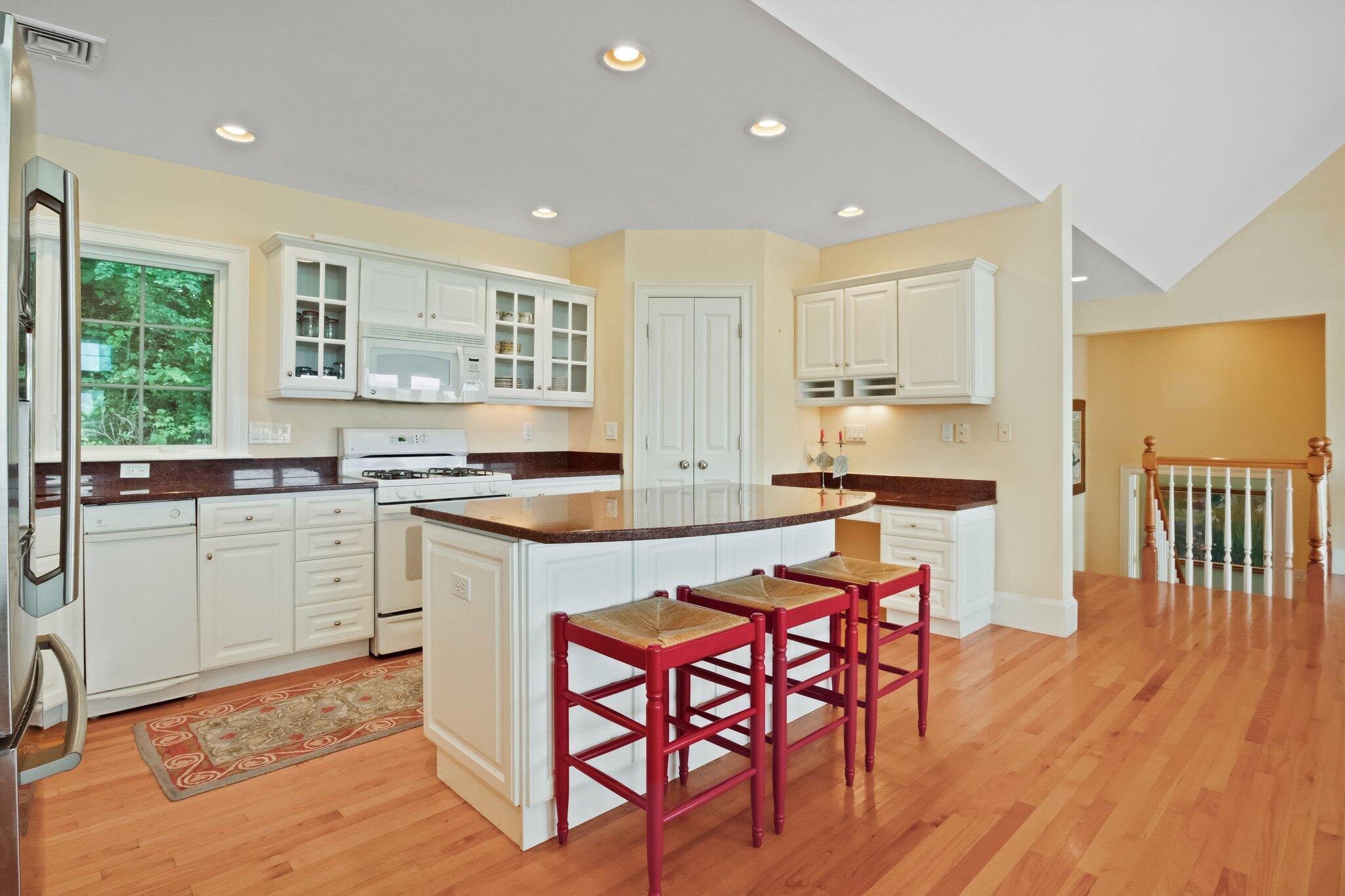 99 Center Lane Centerville, MA 02632 - Photo 25 of 89 a large kitchen with a table and chairs in it