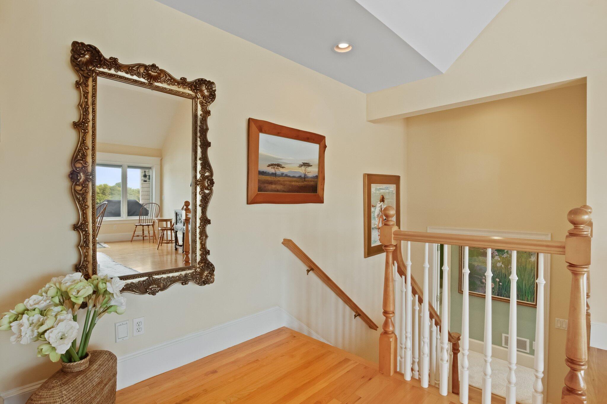 99 Center Lane Centerville, MA 02632 - Photo 27 of 89 a view of a hallway with wooden floor and stairs