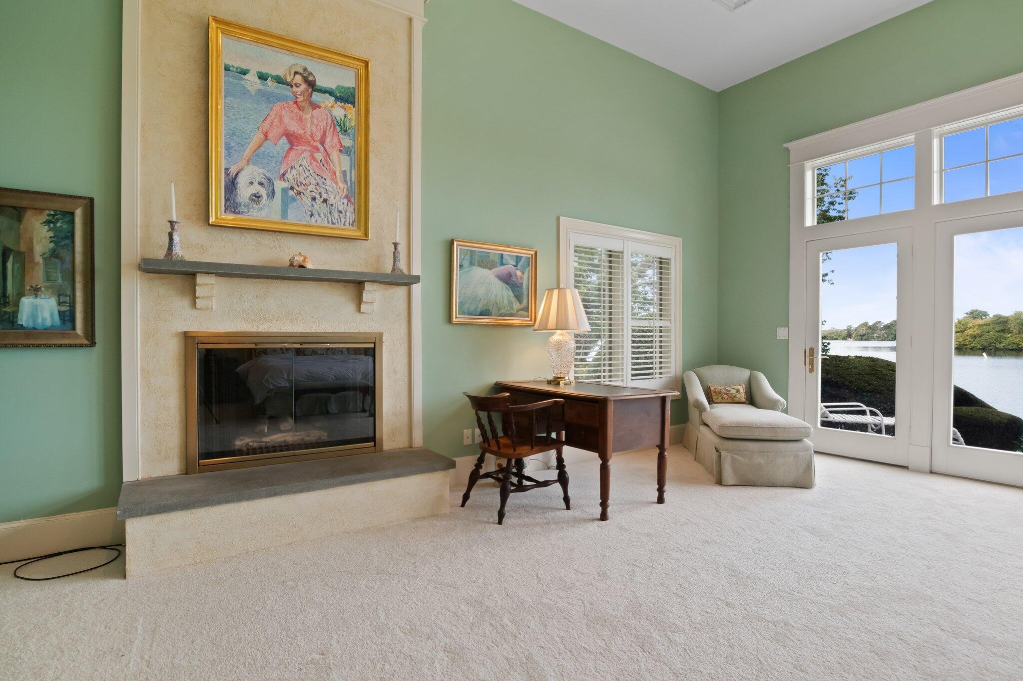 99 Center Lane Centerville, MA 02632 - Photo 29 of 89 a living room with furniture a fireplace and a painting