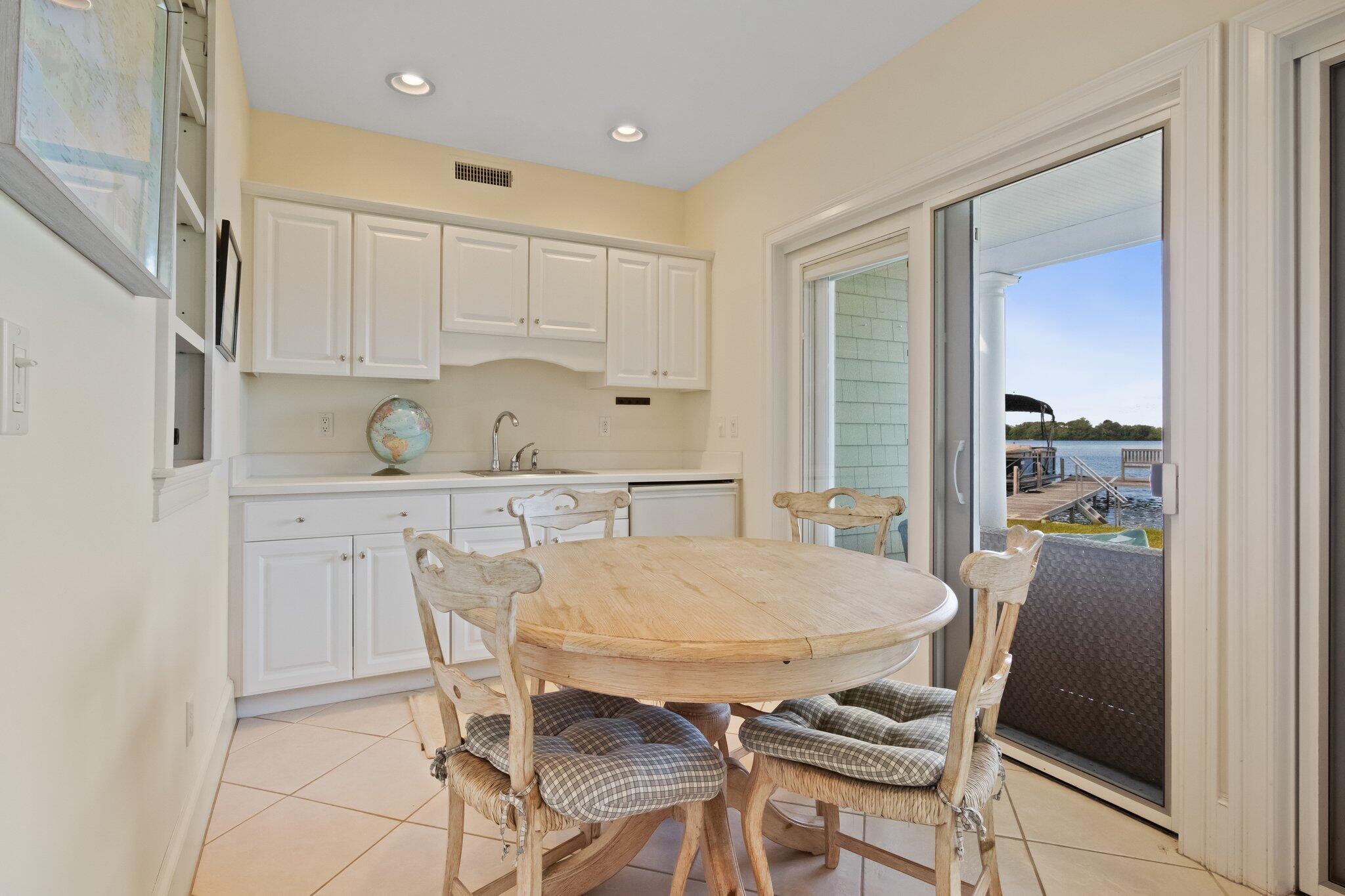 99 Center Lane Centerville, MA 02632 - Photo 54 of 89 a kitchen with a table chairs refrigerator and cabinets