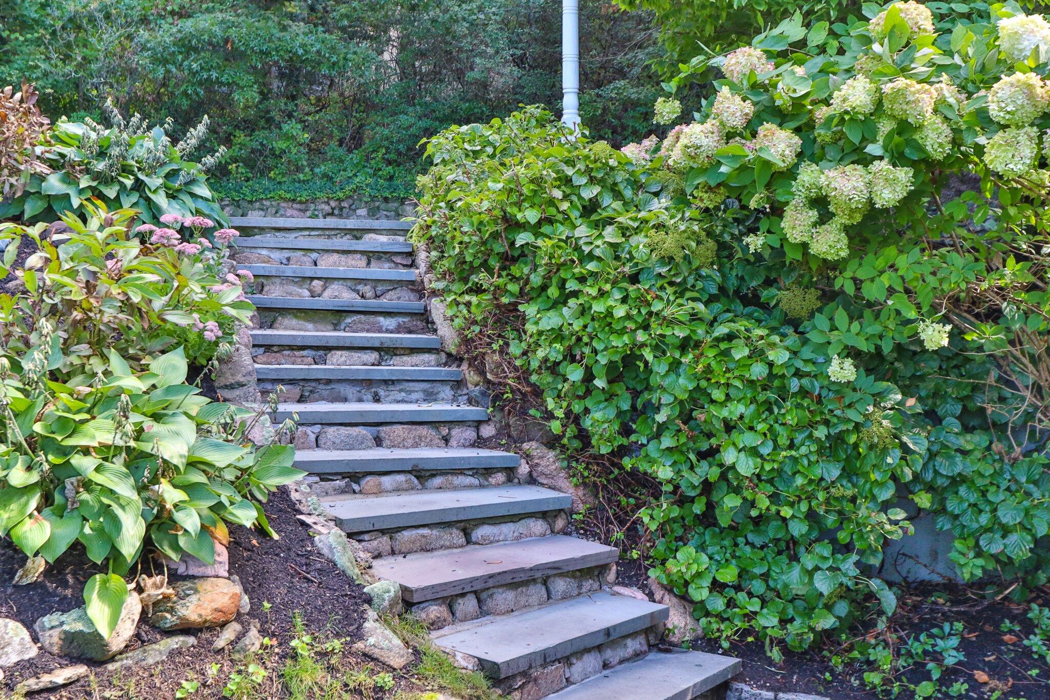 99 Center Lane Centerville, MA 02632 - Photo 70 of 89 a view of a garden with a bench