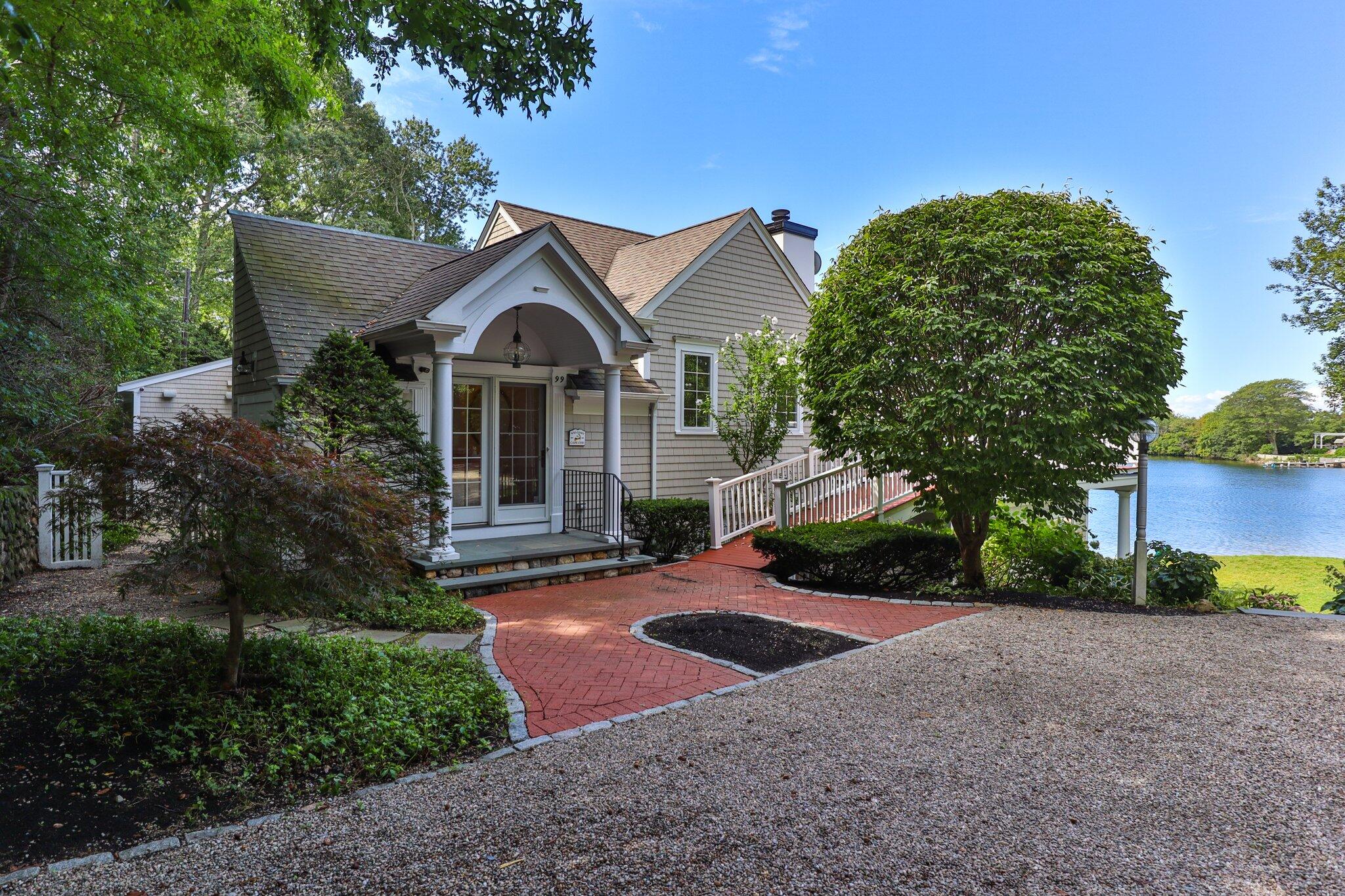 99 Center Lane Centerville, MA 02632 - Photo 7 of 89 a front view of a house with a yard and garage