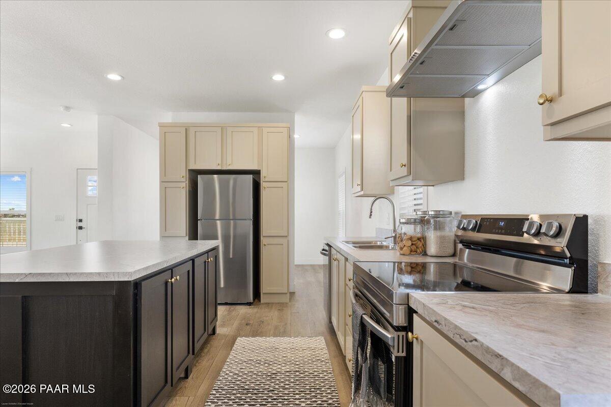 65 Hawaii Road Paulden, AZ 86334 - Photo 6 of 29 a kitchen with stainless steel appliances granite countertop a sink stove and refrigerator