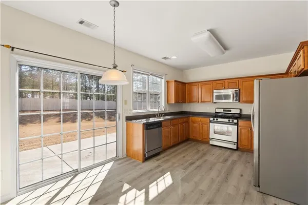 a kitchen with stainless steel appliances granite countertop a stove and a refrigerator