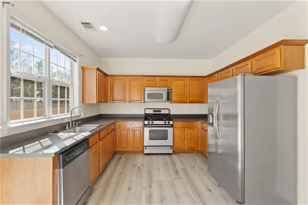 a kitchen with a sink stove and refrigerator