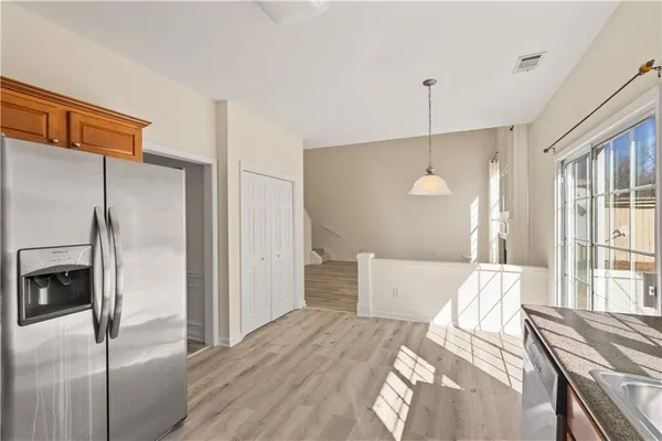 a bedroom with a bed and a refrigerator