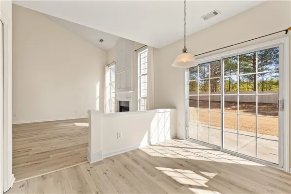 a view of a room with wooden floor and windows