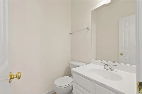a white toilet sitting next to a bathroom sink
