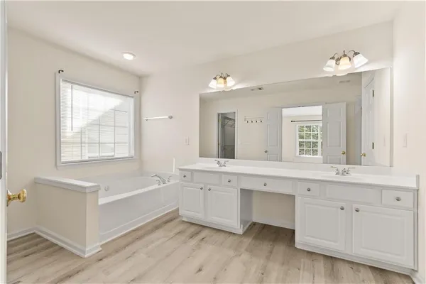 a bathroom with a double vanity sink and mirror with shower