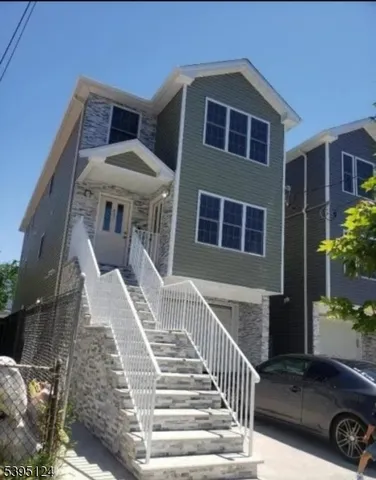 a front view of a house with stairs