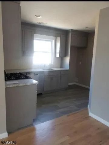 a room with wooden floor and window