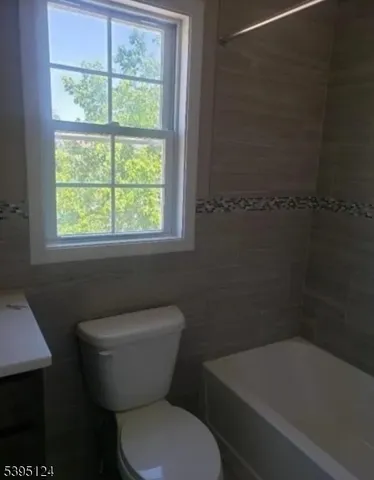 a bathroom with a toilet a sink and a bathtub