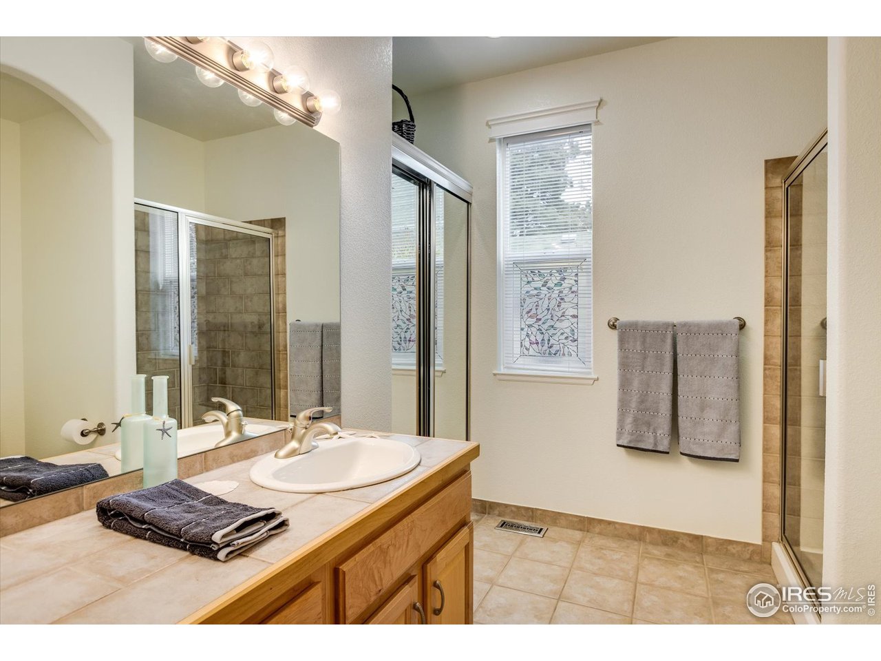 1241 High Street Boulder, CO 80304 - Photo 12 of 36 a bathroom with a sink double vanity and a mirror
