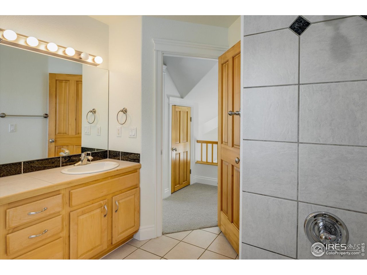 1241 High Street Boulder, CO 80304 - Photo 21 of 36 a bathroom with a granite countertop sink a mirror and shower