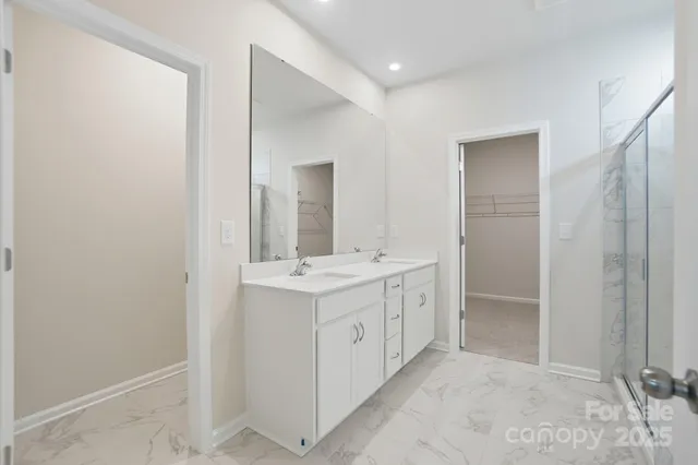 a view of bathroom with a sink a mirror and a shower