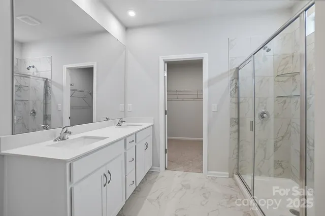 a bathroom with a double vanity sink mirror and shower