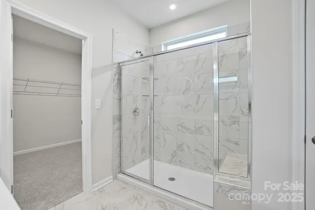a bathroom with a glass shower door