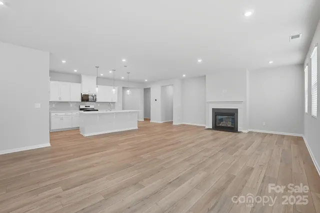 a view of kitchen with granite countertop cabinets and wooden floor