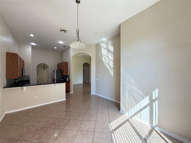 a view of a kitchen with a sink and a chandelier