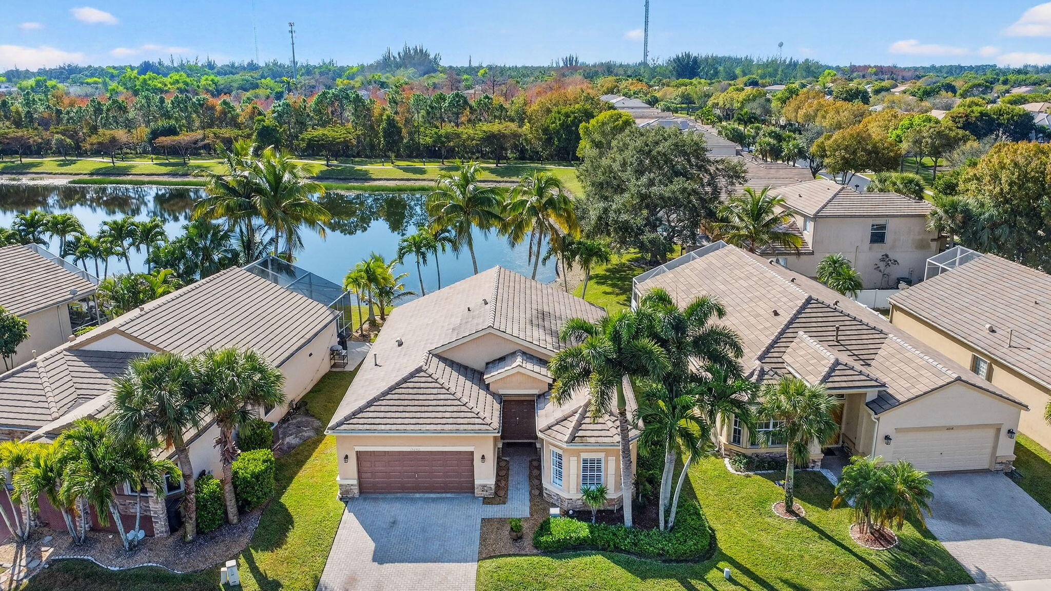 an aerial view of a house with a yard and lake view