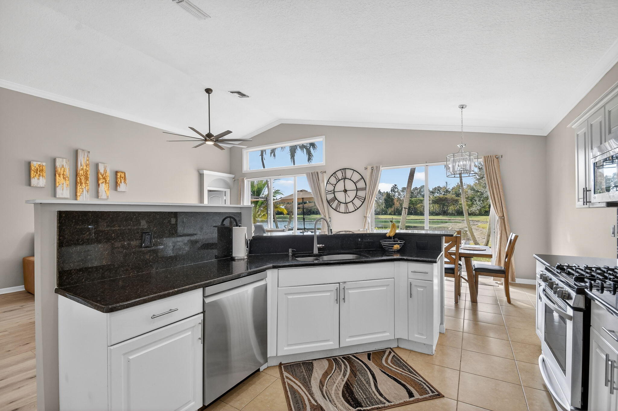 10202 Clubhouse Turn Road Lake Worth, FL 33449 - Photo 4 of 21 a kitchen with granite countertop a stove and a table