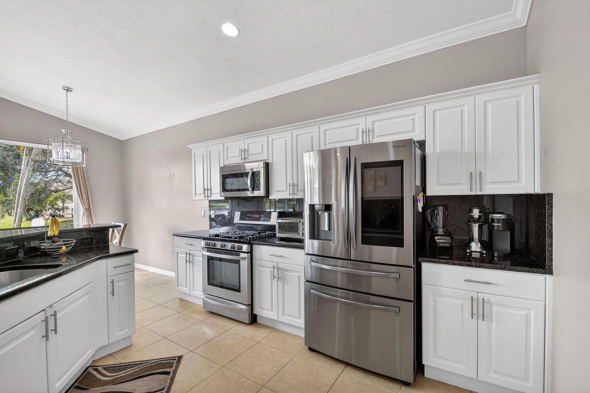 10202 Clubhouse Turn Road Lake Worth, FL 33449 - Photo 5 of 21 a kitchen with stainless steel appliances and cabinets