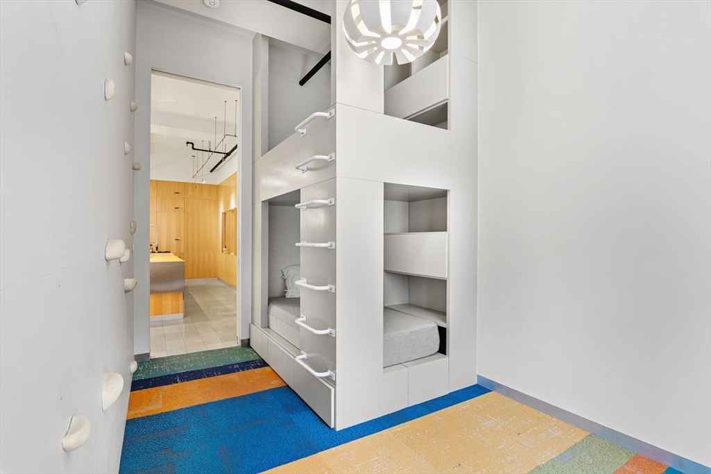 453 Washington Street, Unit 3A Boston, MA 02111 - Photo 16 of 18 a room with a mirror and a rug