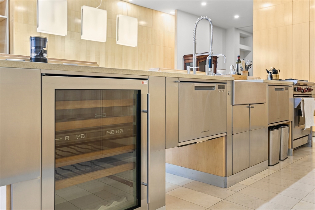 453 Washington Street, Unit 3A Boston, MA 02111 - Photo 4 of 18 a kitchen with stainless steel appliances cabinets and a window