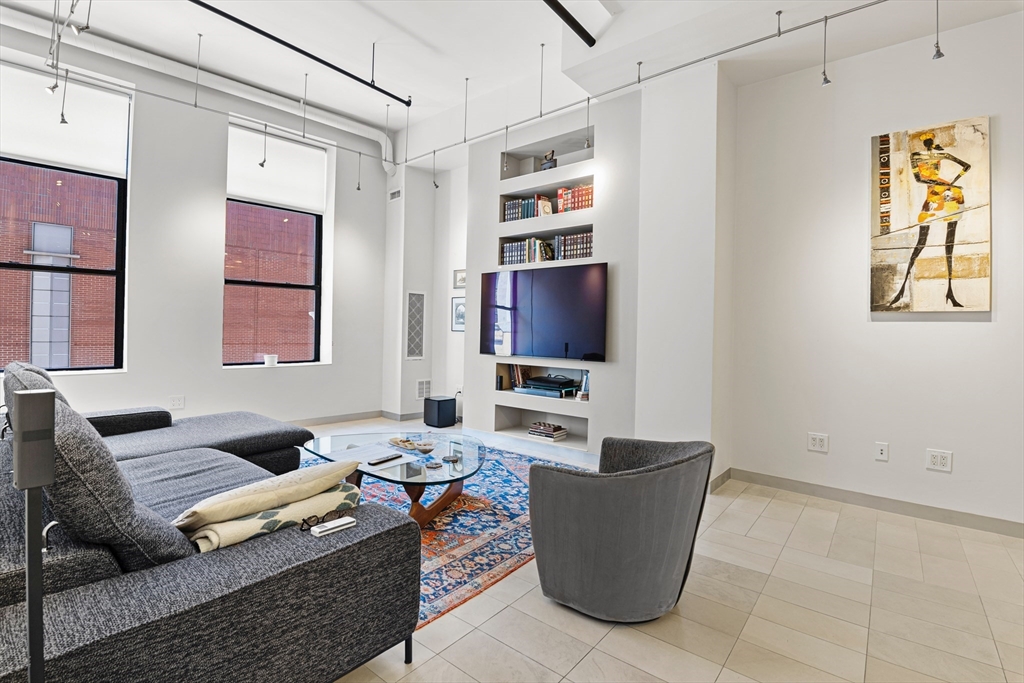 453 Washington Street, Unit 3A Boston, MA 02111 - Photo 5 of 18 a living room with furniture and a flat screen tv