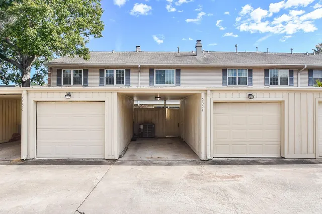 a view of a white house with large windows and a sink