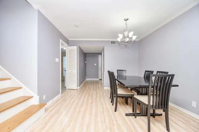 a dining room with furniture and chandelier