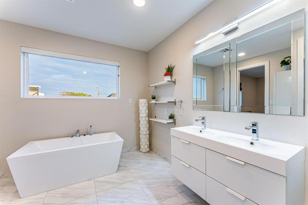 4013 Ivanhoe Lane Dallas, TX 75212 - Photo 18 of 38 Bathroom featuring a tub to relax in and vanity