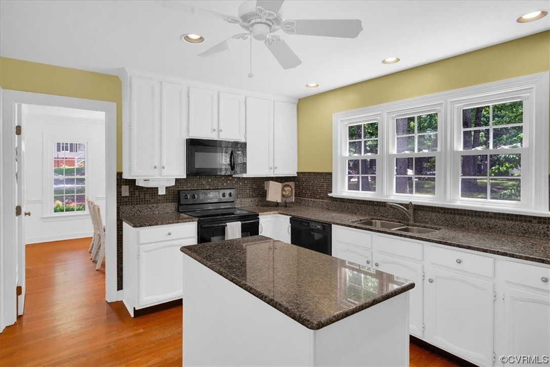 12516 Eagle Ridge Road Henrico, VA 23233 - Photo 14 of 48 Kitchen featuring a kitchen island, a ceiling fan, natural light, electric range oven, dishwasher, microwave, light hardwood flooring, white cabinetry, and dark granite-like countertops