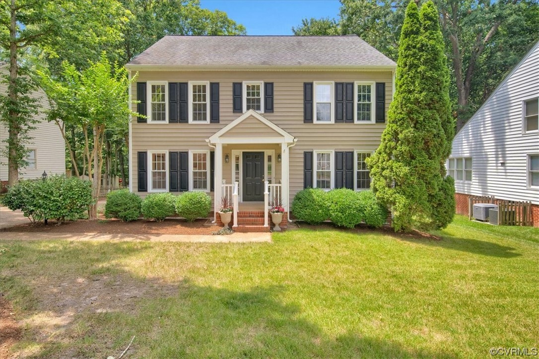Colonial home featuring a front yard