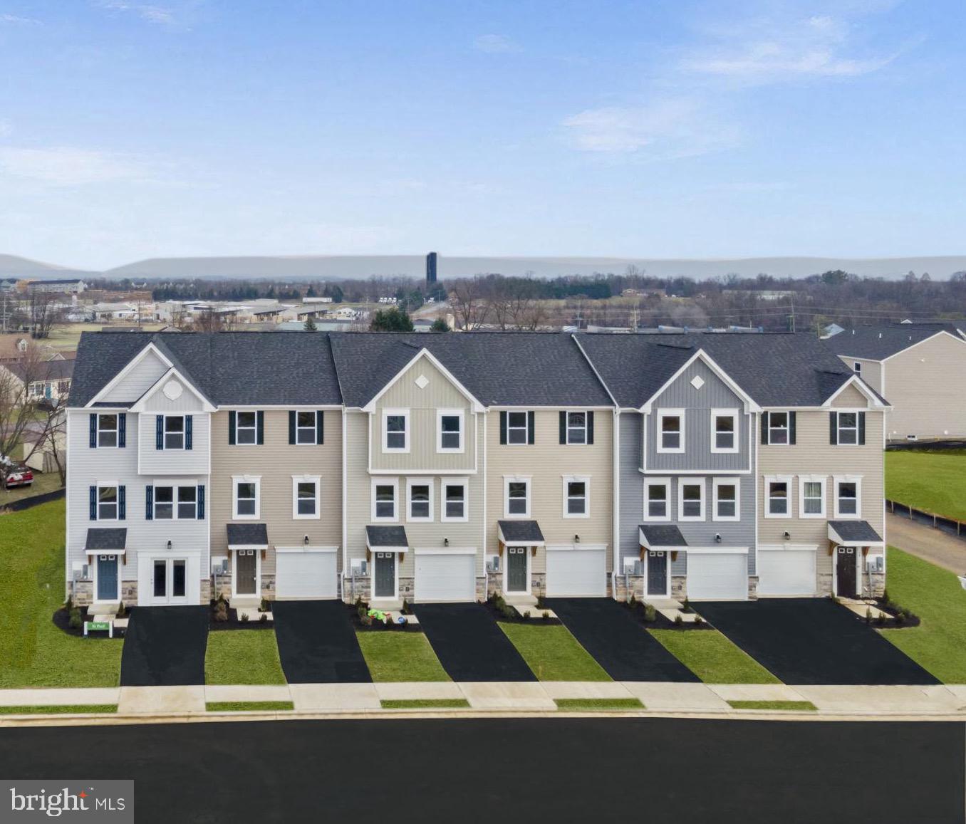 an aerial view of residential houses with street