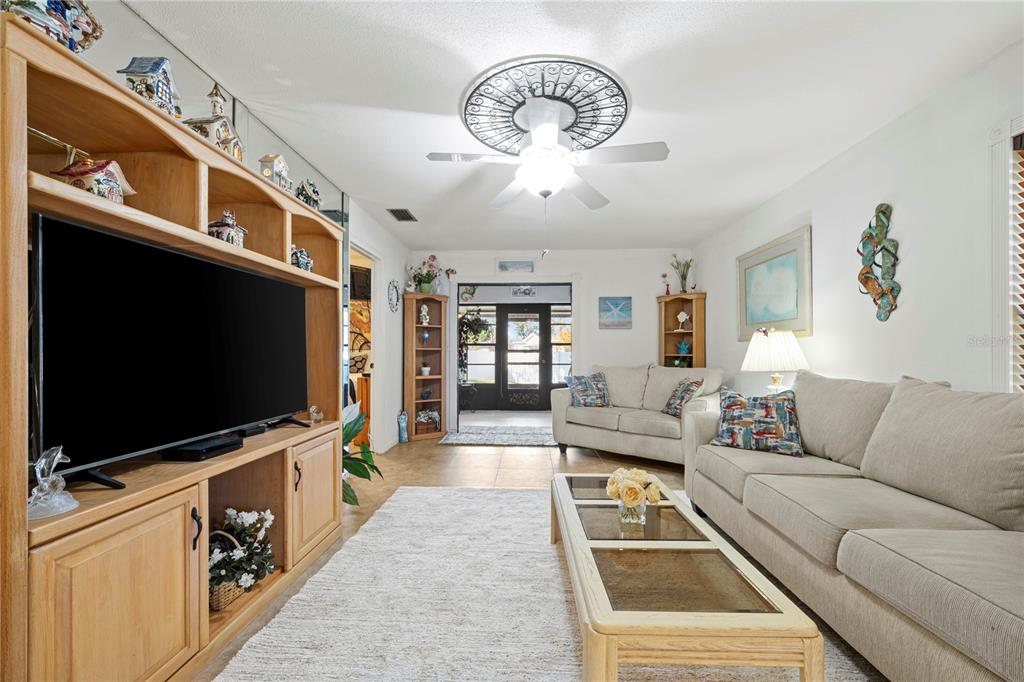7360 Ulmerton Road, Unit 15D Largo, FL 33771 - Photo 16 of 75 a living room with furniture and a flat screen tv