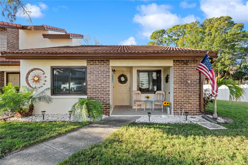 7360 Ulmerton Road, Unit 15D Largo, FL 33771 - Photo 2 of 75 a front view of a house with garden